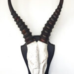 Wooden skull horn sculpture