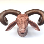 Wooden ram's head sculpture